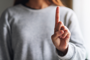Warning sign raised finger