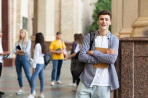 student guy posing to camera with books having br 2023 11 27 05 19 23 utc 1 scaled